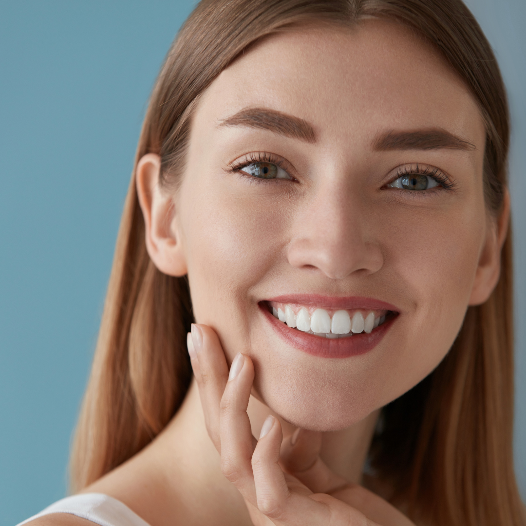 A woman with pearly white teeth smiles for the camera.