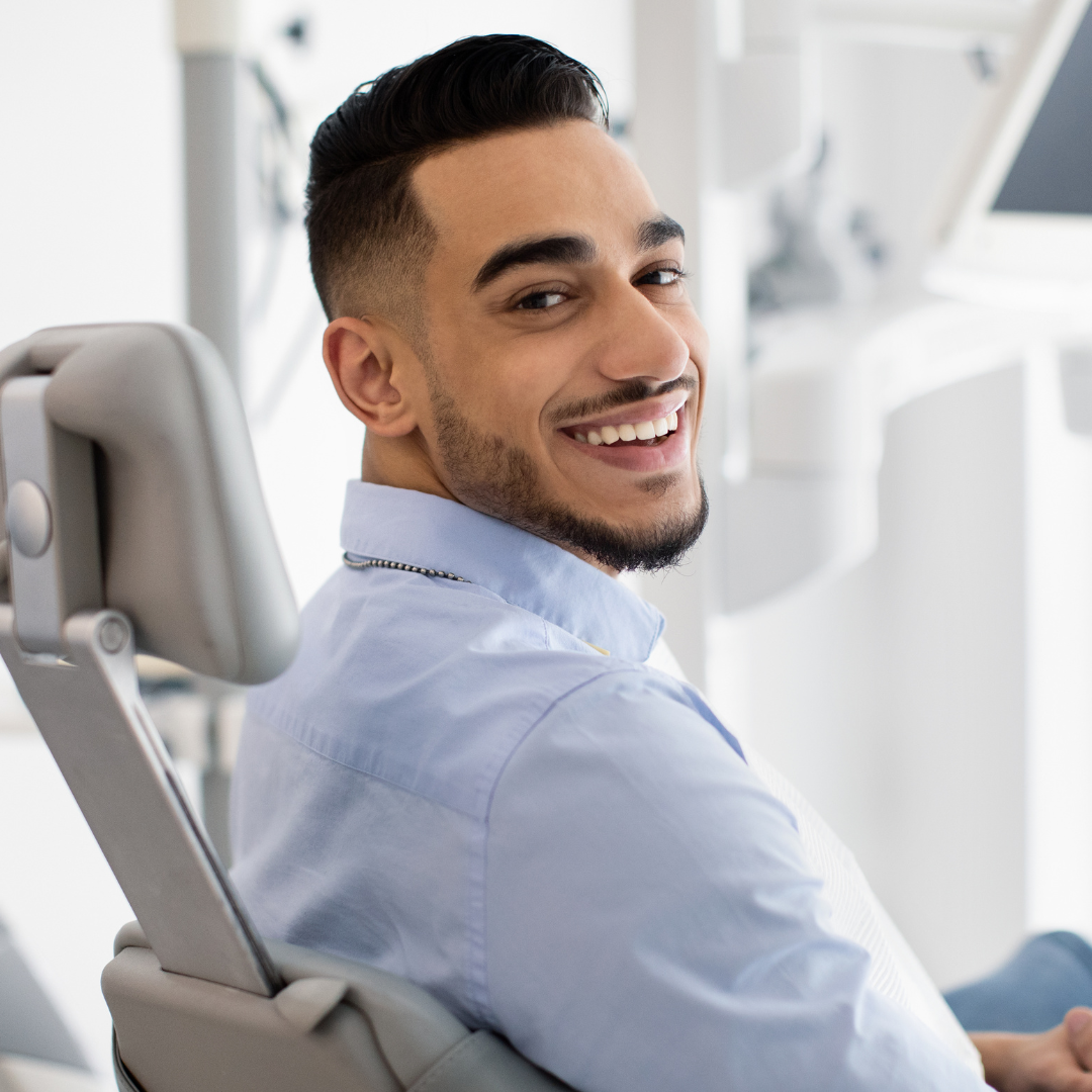 A patient smiles after a successful cosmetic dentistry.